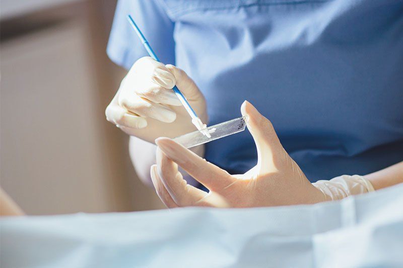 Patient completing a cancer screening test at a clinic, representing the importance of staying up-to-date on recommended screening schedules