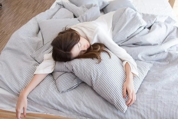 Person sleeping showing the importance of quality sleep for cancer prevention