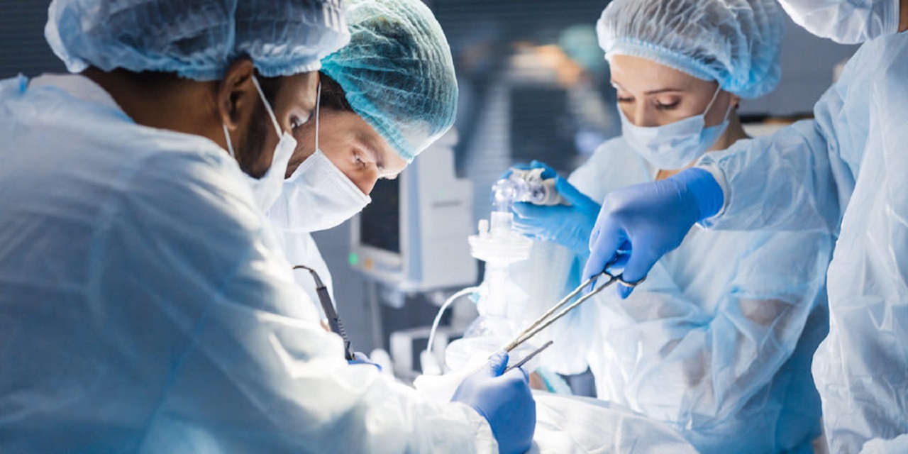 Cancer surgery procedure showing surgical team performing oncologic tumor resection in operating room