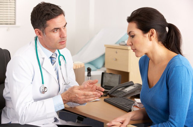 Oncology consultation showing a patient reviewing cancer treatment options with a physician