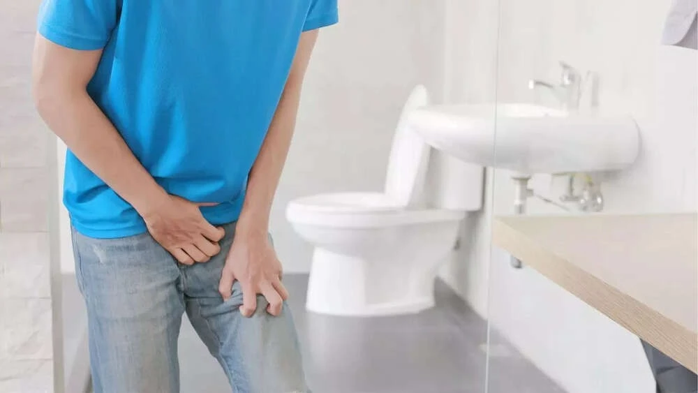 frequent urination prostate cancer — man over 50 discussing urinary symptoms with doctor