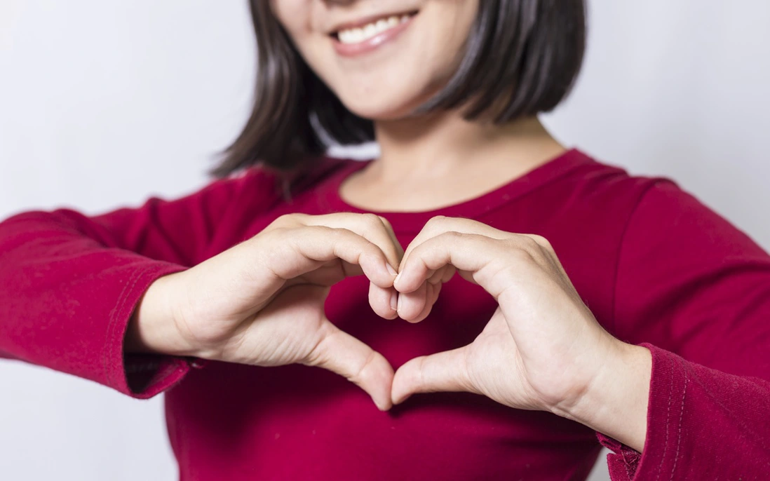 Hands forming a heart shape representing signs of a healthy heart and cardiovascular wellness
