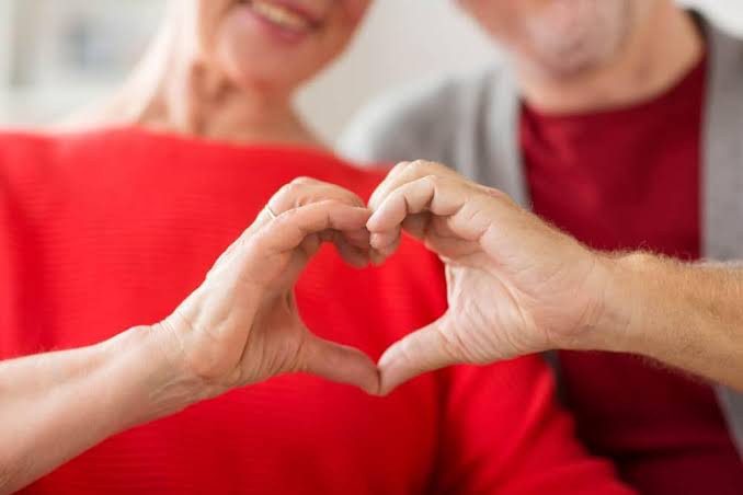 older adult reviewing annual heart health blood test results with physician