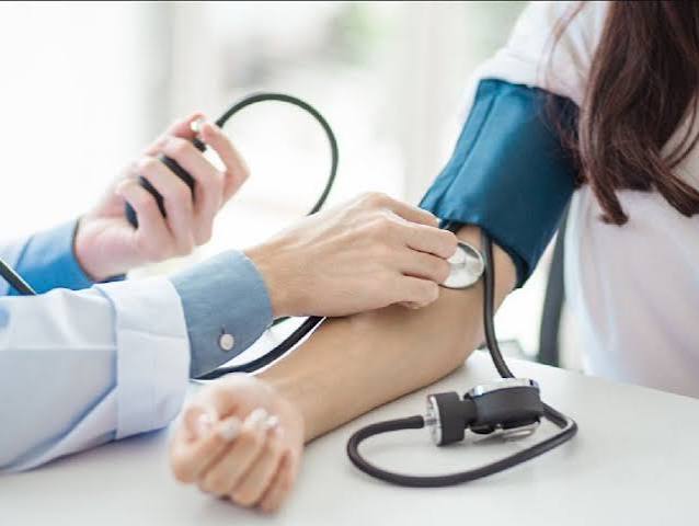 home blood pressure monitor diabetes — digital automatic blood pressure cuff with reading display showing systolic and diastolic pressure for diabetes self-monitoring