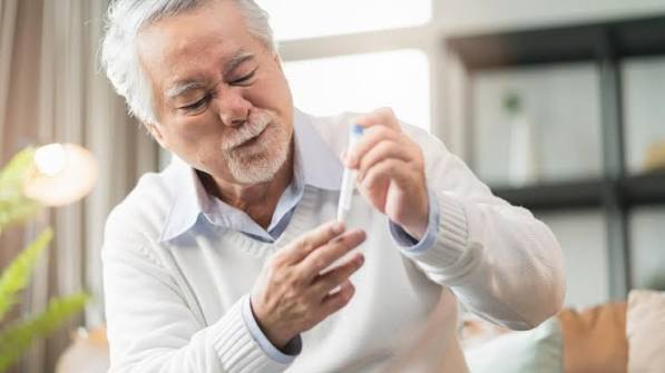 doctor discussing diabetes treatment plan with an elderly patient including medication review and glucose goals