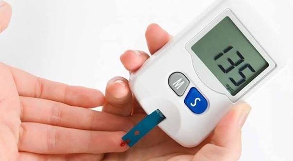 Glucose meter components showing test strip lancet lancing device and blood drop for complete home blood sugar monitoring setup