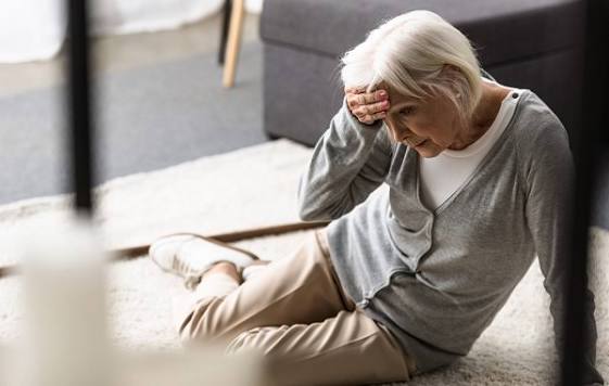 older adult measuring blood pressure to monitor orthostatic hypotension fall risk