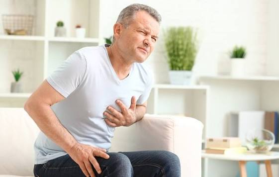 Doctor measuring waist circumference as part of metabolic syndrome and heart disease risk assessment