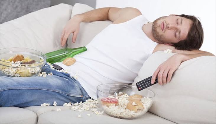 person sitting at desk for long hours representing sedentary lifestyle and blood sugar risk