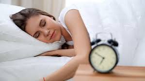 sleep habits and diabetes prevention — woman sleeping peacefully in dark bedroom