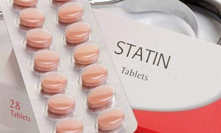 Statins what adults should know — statin medication tablets next to a cholesterol test result