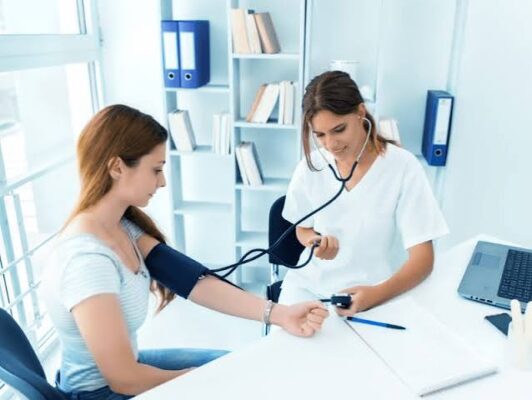 Patient talking to doctor about blood pressure readings during a medical consultation