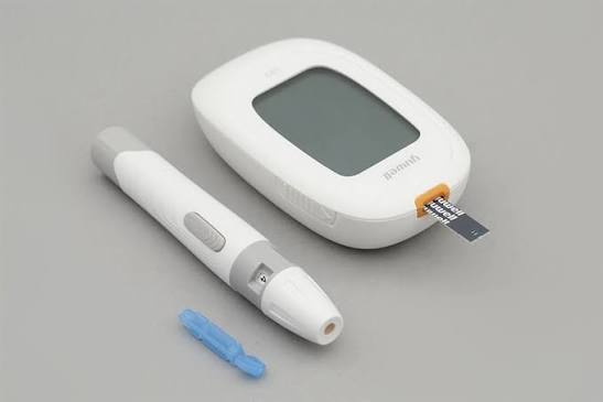 close up of a blood glucose meter display showing a reading with test strip being inserted demonstrating proper testing technique