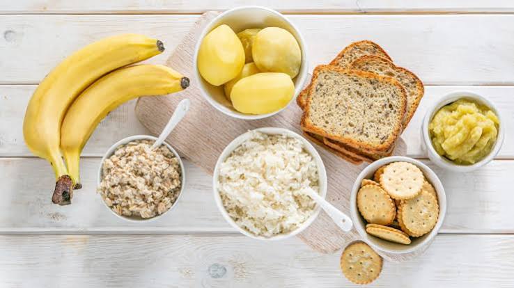 High-fibre foods for constipation relief including prunes, whole grains, legumes, vegetables and flaxseed