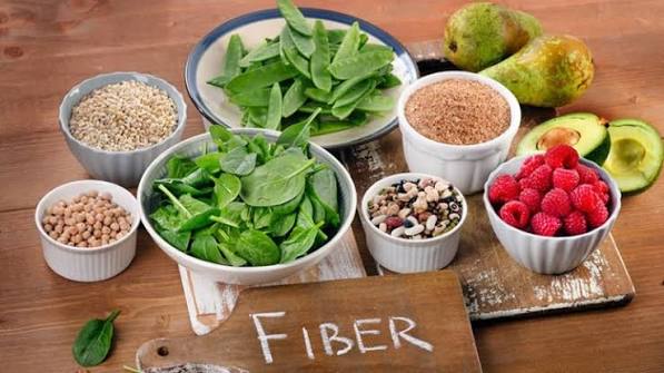 High-fibre foods for constipation relief including prunes, whole grains, oats, legumes and vegetables