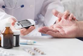 diabetes emergency symptoms — adult being helped by paramedics after collapsing outdoors showing classic signs of a diabetes emergency including pale skin, diaphoresis, and loss of consciousness
