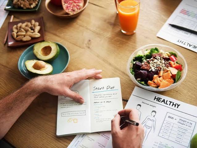 meal planning for chronic kidney disease — weekly CKD meal plan with kidney-friendly breakfast, lunch, dinner, and snack options written on a planning sheet