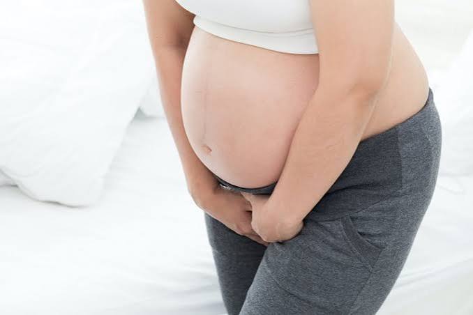 Pregnancy and urinary health — pregnant woman experiencing urinary frequency and urgency illustrating how the growing uterus and hormonal changes affect bladder function during gestation