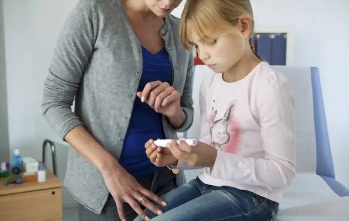 sick-day planning for diabetes — adult resting with glucose meter and hydration on bedside table