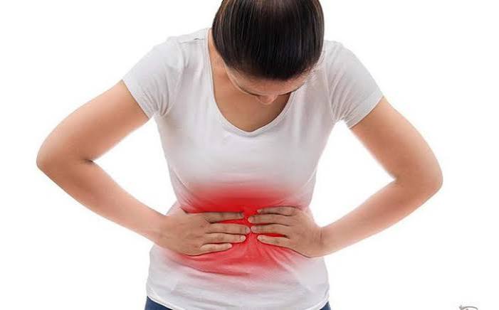Person sleeping peacefully in a dark room showing the importance of quality sleep for digestive health and gut microbiome