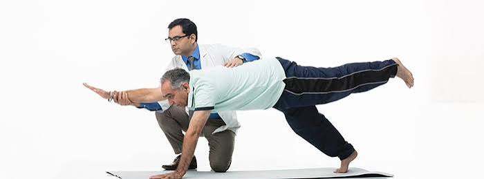 strength training for type 2 diabetes — middle-aged adult with diabetes performing a dumbbell squat in a gym with proper form demonstrating controlled descent with knees tracking over toes and a neutral spine