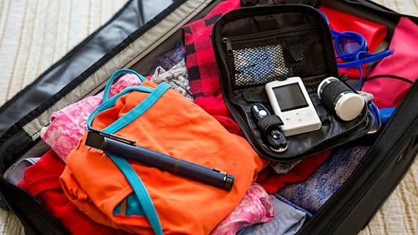 organized diabetes travel kit with insulin, glucose meter, snacks, and medical documentation
