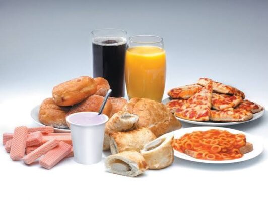 Ultra-processed packaged foods including chips, instant noodles, and processed meats that disrupt gut microbiome and digestive health