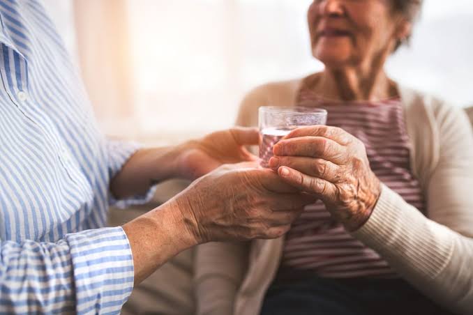 UTI in older adults — elderly patient and caregiver discussing confusing or atypical UTI symptoms with a healthcare provider