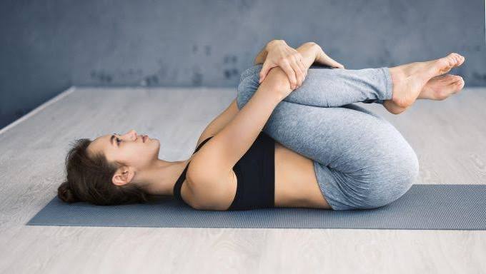 Person sitting upright practicing breathing exercises for digestive comfort and IBS relief through controlled diaphragmatic breathing