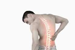 When back pain needs medical attention — adult holding lower back showing features of serious versus mechanical back pain