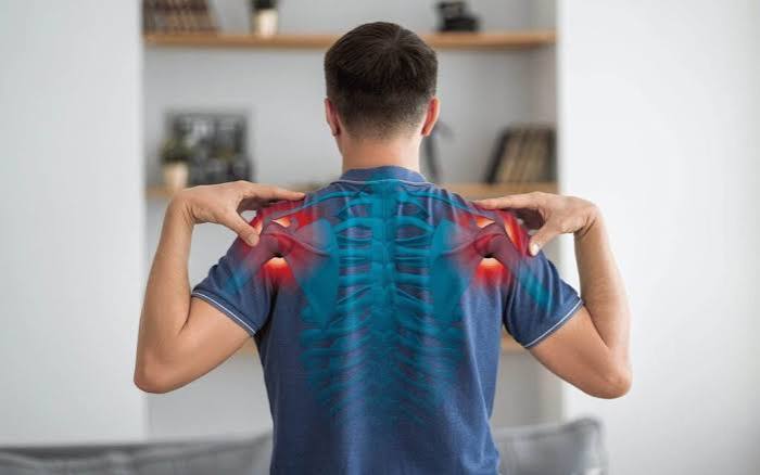 Frozen shoulder adhesive capsulitis diagram showing thickened contracted glenohumeral joint capsule with restricted range of movement and loss of external rotation compared to a normal shoulder joint