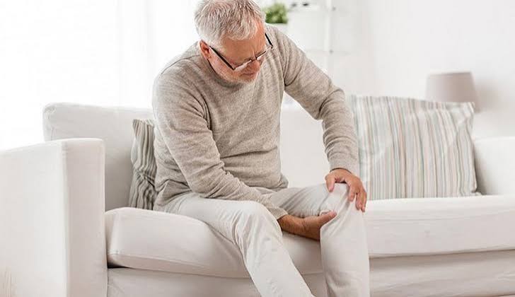 Morning joint stiffness what it may indicate — person struggling to move stiff hands in the morning suggesting inflammatory arthritis or osteoarthritis