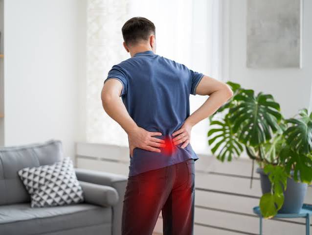 Pain that travels down the leg — adult holding thigh and calf showing radiating leg pain from nerve compression or vascular disease