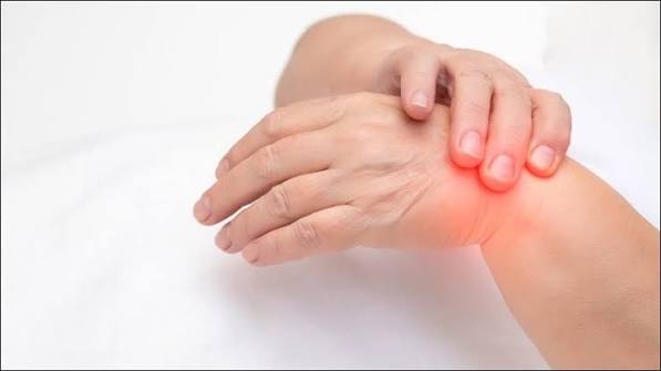 Swollen joints possible causes — adult holding swollen knee or hand showing joint inflammation