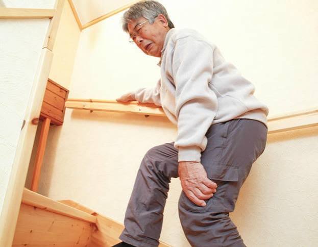 Difficulty walking musculoskeletal — older adult with walking stick showing gait difficulty from hip or knee osteoarthritis or neurological condition