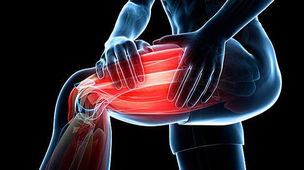 Muscle cramps causes and prevention — adult massaging calf during nocturnal leg cramp showing involuntary muscle contraction