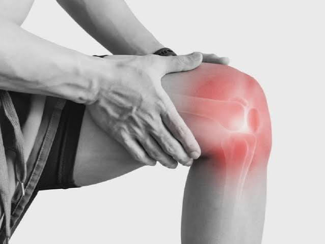 Knee pain what adults should know — featured image showing person holding painful knee