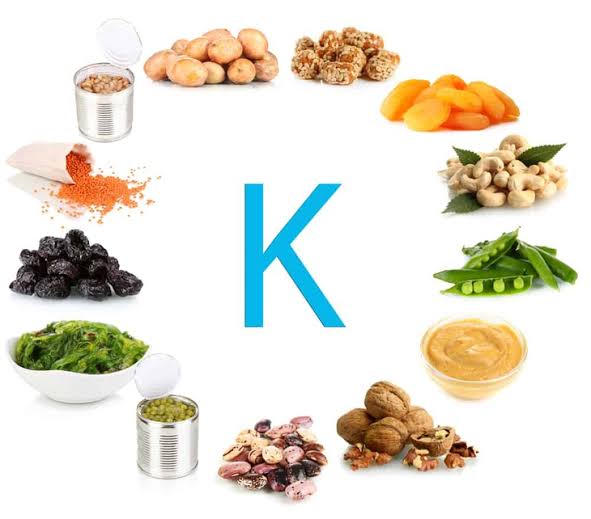 Vitamin K and bone health diagram showing vitamin K1 from green leafy vegetables and vitamin K2 from fermented foods and cheese as dietary sources alongside the carboxylation mechanism activating osteocalcin and matrix Gla protein for bone mineralisation and vascular protection
