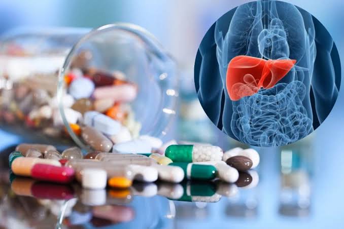 Bottles of dietary and herbal supplements including green tea extract and weight loss supplements, illustrating the variety of supplement products associated with documented liver injury in clinical case series